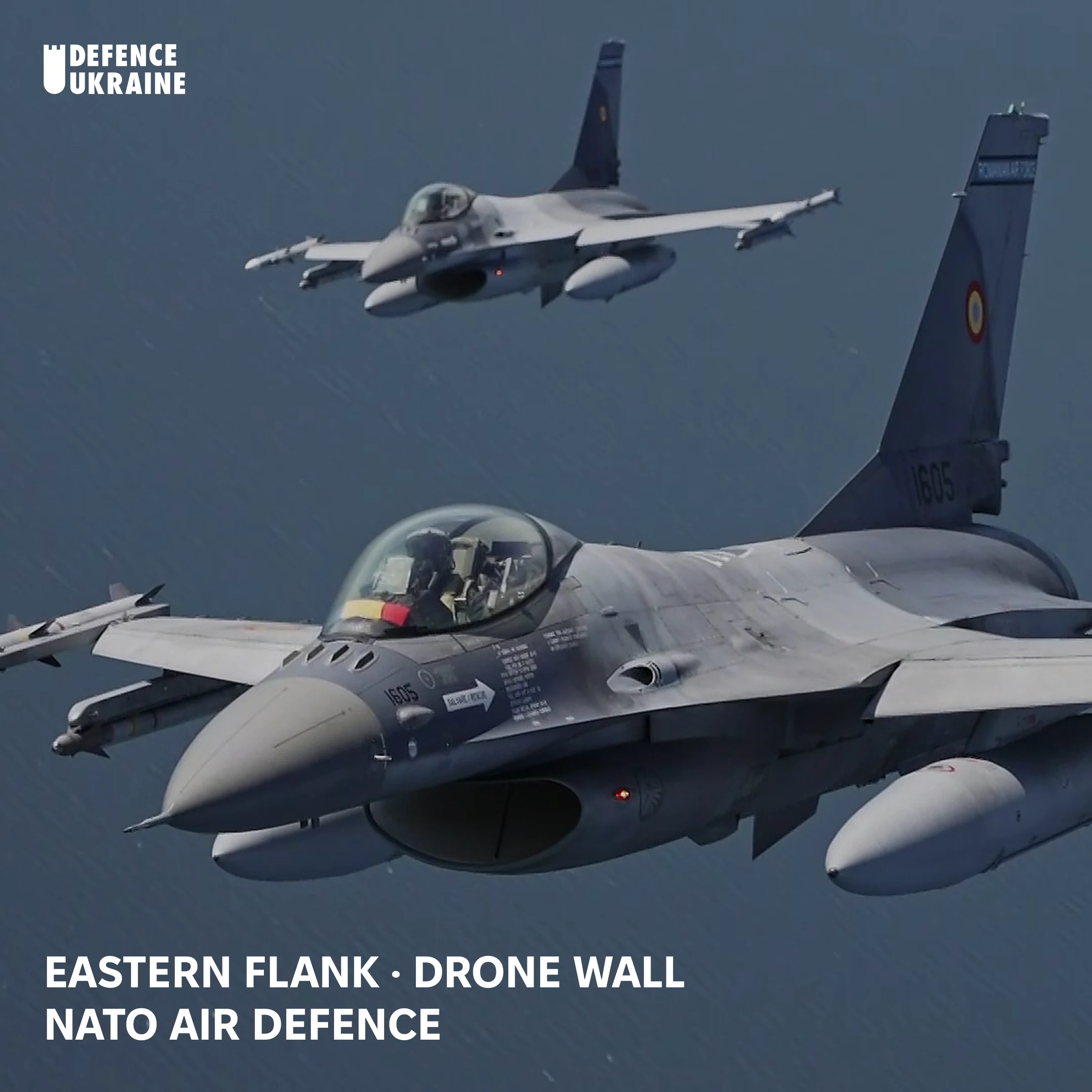 Two Romanian Air Force F-16 fighter jets in formation over the Baltic Sea on NATO Baltic Air Policing patrol, the type of mission now scrambled against Ukrainian drones drifting into NATO airspace after Russian electronic warfare severs their navigation links.