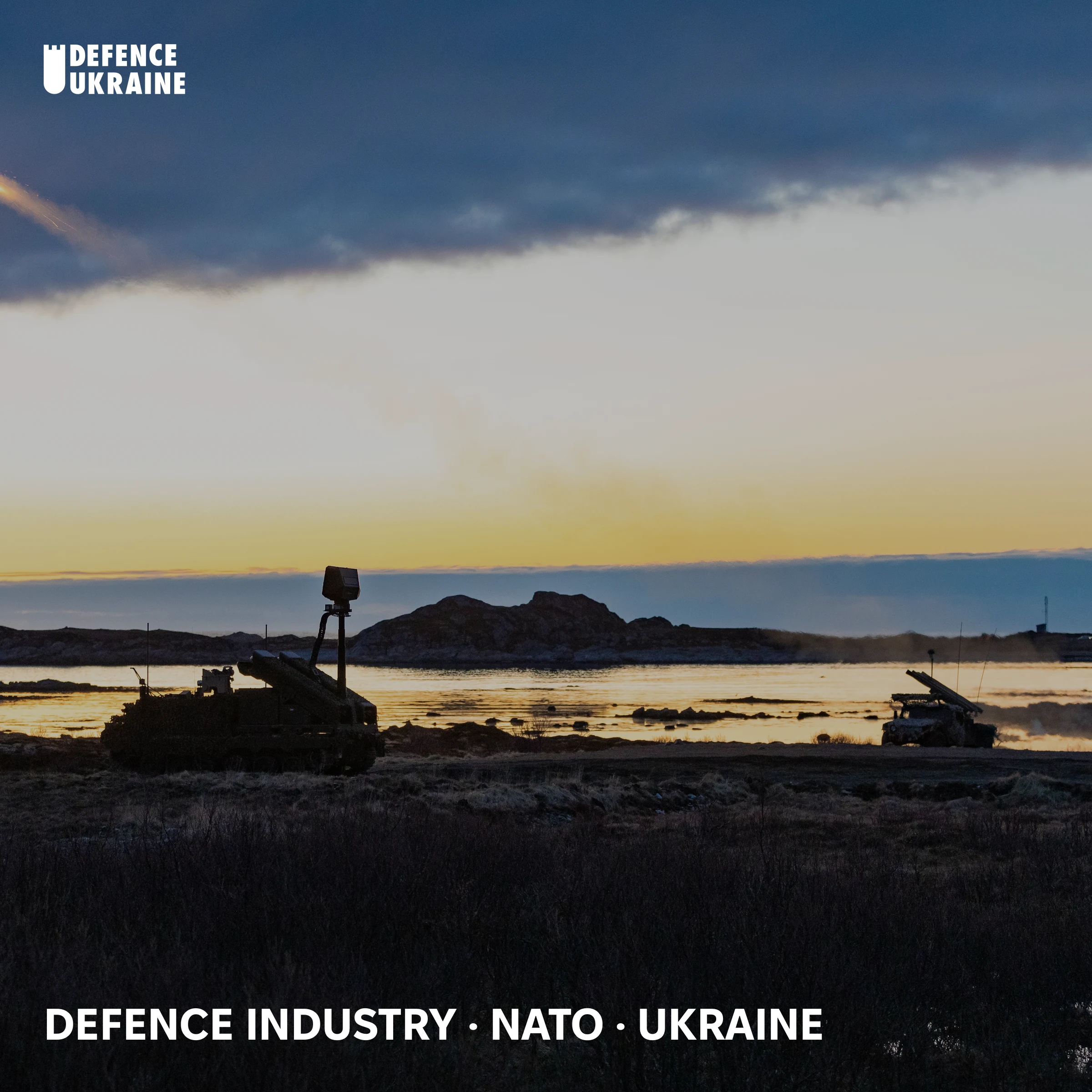 Two NASAMS air-defence systems silhouetted at sunset during NATO exercise Formidable Shield 2025, Andøya, Norway. The Norwegian-developed platform anchors the European procurement architecture built around Ukraine-tested combat data.