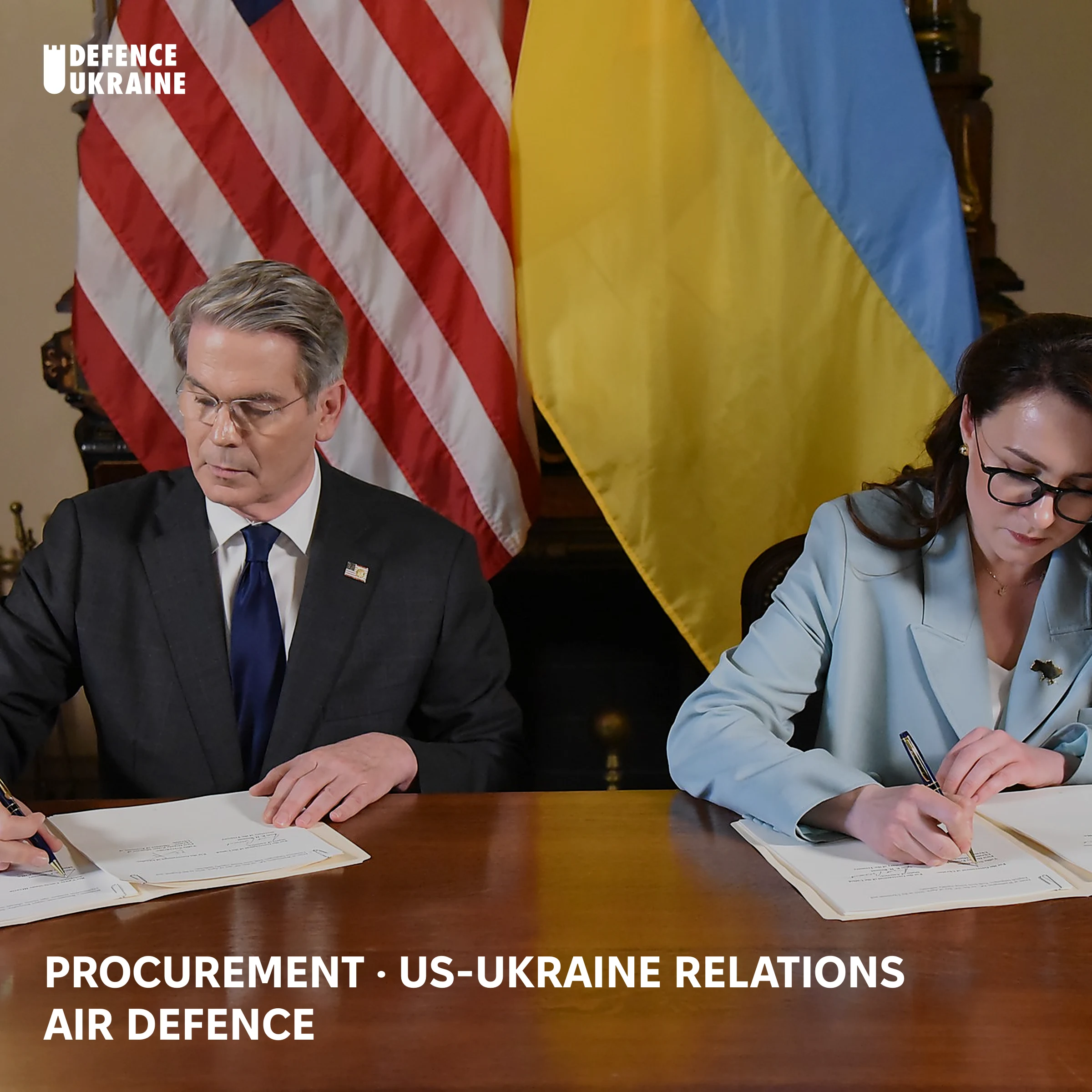 US Treasury Secretary Scott Bessent and Ukrainian First Deputy Prime Minister Yulia Svyrydenko signing the April 2025 agreement that created the US-Ukraine Reconstruction Investment Fund, in front of US and Ukrainian flags.